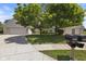 Charming facade showing a well-maintained lawn, mature trees, and an attached two-car garage at 10934 Harness Ct, Indianapolis, IN 46239