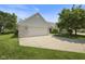 Charming house with a spacious driveway leading to an attached two-car garage, perfect for parking and storage at 10934 Harness Ct, Indianapolis, IN 46239