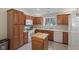 Well-equipped kitchen with an island, white appliances, and bright window views at 10934 Harness Ct, Indianapolis, IN 46239