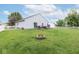 Lush backyard featuring a well-manicured lawn, wooden deck, fire pit, perfect for outdoor entertaining and relaxation at 10973 Freeman Ct, Indianapolis, IN 46234