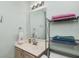 Bathroom featuring a vanity with storage, a shelf for towels, and a large mirror at 10973 Freeman Ct, Indianapolis, IN 46234