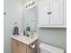 Well-lit bathroom with a single sink vanity, and a medicine cabinet at 10973 Freeman Ct, Indianapolis, IN 46234