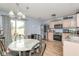 Bright kitchen with stainless appliances, light cabinetry and a adjacent dining area with a view to the back yard at 10973 Freeman Ct, Indianapolis, IN 46234