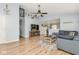 Open-concept living room with adjacent dining and kitchen area and stylish wood-look floors at 10973 Freeman Ct, Indianapolis, IN 46234