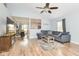 Open-concept living room featuring wood-look flooring, a ceiling fan and comfortable seating at 10973 Freeman Ct, Indianapolis, IN 46234