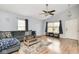 Bright living room with a vaulted ceiling, ceiling fan and comfortable gray seating arrangement at 10973 Freeman Ct, Indianapolis, IN 46234