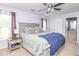 Relaxing main bedroom with large window, bedside table, and a connecting door to the bathroom at 10973 Freeman Ct, Indianapolis, IN 46234