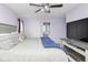 Large main bedroom featuring a TV, a connecting door to the bathroom, and plush bedding at 10973 Freeman Ct, Indianapolis, IN 46234