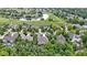 Breathtaking aerial view showcasing the golf course community with a pond, lush landscaping, and mature trees at 11393 Muirfield Trce, Fishers, IN 46037