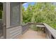 Balcony with a table and chairs offers a cozy outdoor space with views of the surrounding trees at 11393 Muirfield Trce, Fishers, IN 46037