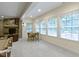 Basement with natural light has a fireplace with stone surround, a table and chairs, and a pool table at 11393 Muirfield Trce, Fishers, IN 46037