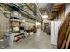 An unfinished basement with exposed ductwork, storage shelving, and a refrigerator at 11393 Muirfield Trce, Fishers, IN 46037