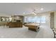 Basement area featuring a pool table, fireplace, and a table next to a large window at 11393 Muirfield Trce, Fishers, IN 46037