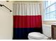 Bathroom featuring white toilet with a red, white, and blue shower curtain at 11393 Muirfield Trce, Fishers, IN 46037