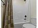 A neutral bathroom featuring a shower/tub with a shower curtain and a toilet at 11393 Muirfield Trce, Fishers, IN 46037