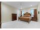 Spacious bedroom with a large bed, dresser, bedside tables, and soft carpeting throughout at 11393 Muirfield Trce, Fishers, IN 46037