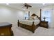 A primary bedroom featuring a four-poster bed, a ceiling fan, and carpeted floors at 11393 Muirfield Trce, Fishers, IN 46037