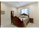 Cozy bedroom featuring a comfortable bed, bedside table, and soothing natural light from the window at 11393 Muirfield Trce, Fishers, IN 46037