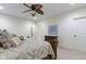 A carpeted bedroom featuring a bed with detailed wood frame and a ceiling fan at 11393 Muirfield Trce, Fishers, IN 46037