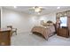 A traditional bedroom with a queen-sized bed, ceiling fan, and carpeted floor at 11393 Muirfield Trce, Fishers, IN 46037