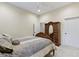 Well-lit bedroom with an inviting bed, ceiling fan, and a classic wooden wardrobe with drawers and mirrored door at 11393 Muirfield Trce, Fishers, IN 46037