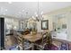 Dining area that flows to kitchen with elegant furnishings and chandelier lighting at 11393 Muirfield Trce, Fishers, IN 46037