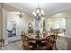 Spacious dining room featuring a round table, stylish chairs, and elegant chandeliers at 11393 Muirfield Trce, Fishers, IN 46037