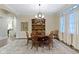 Formal dining room with a round table, ornate chairs, chandelier and large window at 11393 Muirfield Trce, Fishers, IN 46037