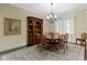 Dining area with round table, decorative chairs, chandelier, and beautiful china cabinet at 11393 Muirfield Trce, Fishers, IN 46037