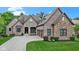 Lovely brick home with a three-car garage, a well-maintained lawn and concrete driveway at 11393 Muirfield Trce, Fishers, IN 46037