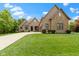 Attractive brick home features mature landscaping and a long driveway leading to a three-car garage at 11393 Muirfield Trce, Fishers, IN 46037