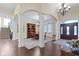 Spacious foyer with hardwood floors, columns, and a view of the dining area at 11393 Muirfield Trce, Fishers, IN 46037