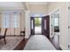 Inviting foyer features dark hardwood floors, a large rug and an open doorway ahead at 11393 Muirfield Trce, Fishers, IN 46037