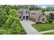 Gorgeous front exterior view highlighting the three-car garage and beautiful landscaping at 11393 Muirfield Trce, Fishers, IN 46037