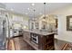 Open kitchen concept with an island and stainless steel appliances at 11393 Muirfield Trce, Fishers, IN 46037