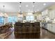 Open layout kitchen with dining area, a large island, and modern appliances at 11393 Muirfield Trce, Fishers, IN 46037