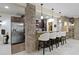 Basement kitchenette featuring modern appliances, bar seating, and elegant lighting fixtures at 11393 Muirfield Trce, Fishers, IN 46037