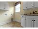 Functional laundry room featuring ample cabinet space and convenient utility connections at 11393 Muirfield Trce, Fishers, IN 46037