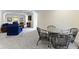 Living room featuring a table with 4 chairs and a seating area with blue chairs at 11393 Muirfield Trce, Fishers, IN 46037