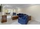 Open living room featuring neutral walls, carpet, and blue seating arrangement at 11393 Muirfield Trce, Fishers, IN 46037