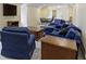 Open living room with neutral walls, blue furniture, and hardwood accent tables at 11393 Muirfield Trce, Fishers, IN 46037