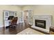 Cozy home office with custom built-ins, decorative fireplace and wood floors at 11393 Muirfield Trce, Fishers, IN 46037