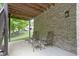 Outdoor patio with brick wall offers a serene space with comfortable seating at 11393 Muirfield Trce, Fishers, IN 46037