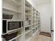 Well-organized pantry with ample shelving and storage, complemented by modern appliances at 11393 Muirfield Trce, Fishers, IN 46037