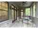 Inviting screened porch with ceiling fan, dining table, and views of the outdoors at 11393 Muirfield Trce, Fishers, IN 46037
