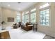 Bright, sun-drenched sitting room with large windows and comfortable seating at 11393 Muirfield Trce, Fishers, IN 46037
