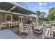 Relaxing outdoor living space featuring a pergola-covered deck, comfortable seating, and outdoor dining area at 11409 Haverstick Rd, Carmel, IN 46033