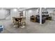 Finished basement with neutral carpet, seating area, dining table, and play area at 11409 Haverstick Rd, Carmel, IN 46033