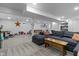Finished basement with neutral carpet, dark sofa, and play area at 11409 Haverstick Rd, Carmel, IN 46033