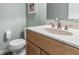 Well-lit bathroom featuring a white vanity top, wood cabinet, and brushed nickel faucet at 11409 Haverstick Rd, Carmel, IN 46033